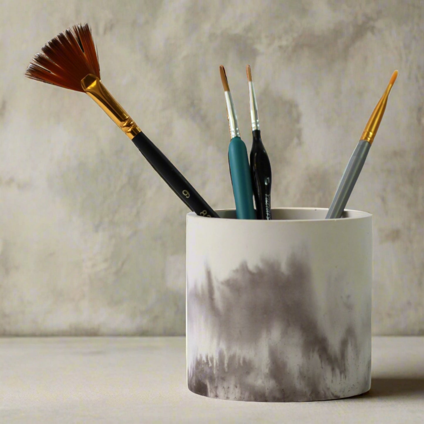 Small catchall container with paint brushes 